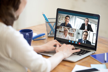 woman videoconferencing with co-workers