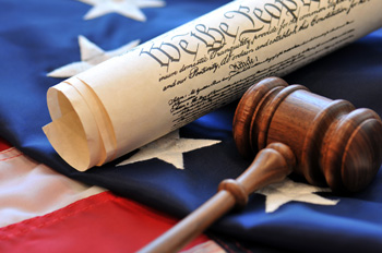 United States flag with Constitution and gavel