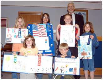 Winners of the Jefferson County Law Day Essay Contest pose in court with Judge William F. Hue, who led the effort to organize events that brought more than 300 children to the courthouse on May 1.  