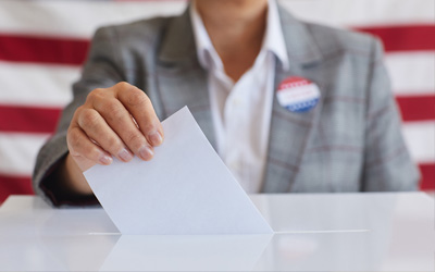 Voter placing a ballot in a ballot box