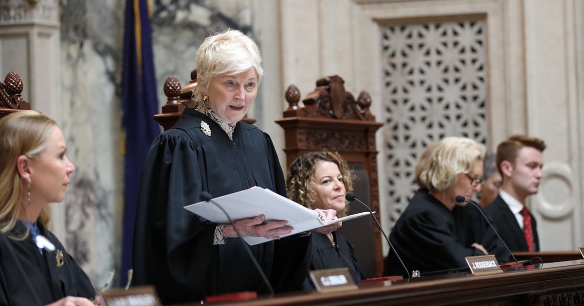 Justice Patience Drake Roggensack administers the oath of office to a group of new lawyers during a ceremony in the Supreme Court Hearing Room in April 2023.